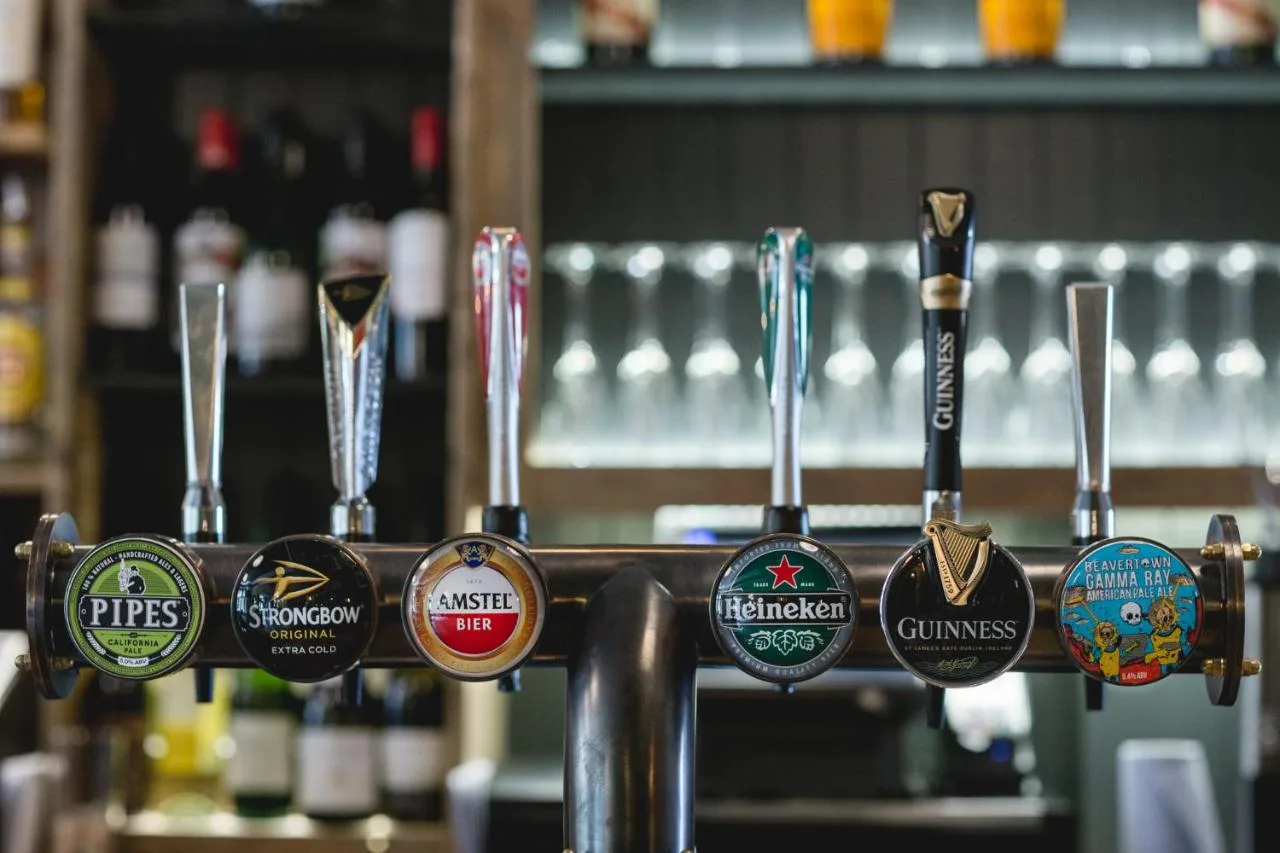 a bar with a bunch of different types of medals at Pontcanna Inn in Cardiff