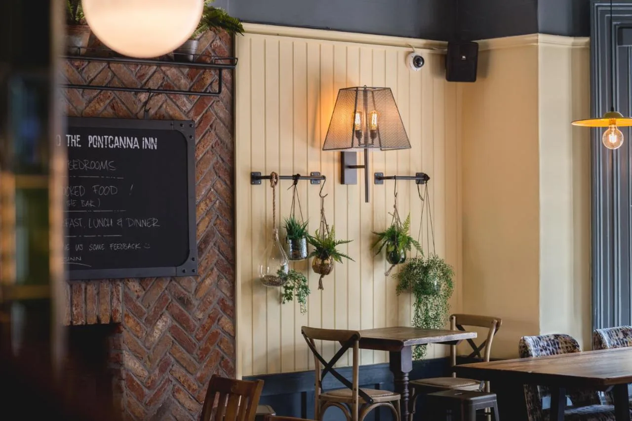 a restaurant with a table and a chalkboard on the wall at Pontcanna Inn in Cardiff